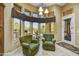 Comfortable sitting area features two armchairs, natural light from large windows, and views of the outdoor space at 4050 N Terra Mesa Cir, Mesa, AZ 85207