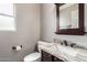 Powder room featuring modern vanity with granite countertop and updated fixtures at 4062 W Cielo Grande --, Glendale, AZ 85310