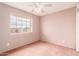 Cozy bedroom with neutral carpet, a bright window, and ample space at 4062 W Cielo Grande --, Glendale, AZ 85310