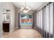 Bright dining area with chandelier, tile floors, and pool view at 4062 W Cielo Grande --, Glendale, AZ 85310