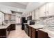 Updated kitchen featuring tile backsplash, stainless steel sink, and black appliances at 4062 W Cielo Grande --, Glendale, AZ 85310