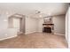 Cozy living room features a classic fireplace, tile floors, and neutral walls at 4062 W Cielo Grande --, Glendale, AZ 85310