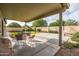 Inviting covered back patio with outdoor seating, perfect for relaxing and entertaining at 4110 E Brighton Way, San Tan Valley, AZ 85140