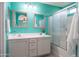 Well-lit bathroom with sleek shower featuring glass doors and vanity with dual mirrors at 4110 E Brighton Way, San Tan Valley, AZ 85140