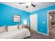 Cheery blue bedroom with a daybed, 'choose joy' sign, and a convenient closet at 4110 E Brighton Way, San Tan Valley, AZ 85140