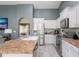 Bright kitchen features white cabinets, stainless appliances and a breakfast bar island with a large sink at 4110 E Brighton Way, San Tan Valley, AZ 85140