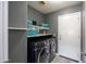 Functional laundry room with modern washer and dryer, shelving, and ample storage space at 4110 E Brighton Way, San Tan Valley, AZ 85140