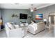 Bright living room with modern decor, tile floors, comfortable seating, and a ceiling fan at 4110 E Brighton Way, San Tan Valley, AZ 85140