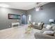 Well-lit living room with comfortable seating, ceiling fan, and neutral color scheme at 4110 E Brighton Way, San Tan Valley, AZ 85140