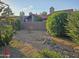 The backyard features desert landscaping, a statue, and mature greenery at 4116 E Lupine Ave, Phoenix, AZ 85028