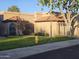 Charming, single-story home with well-maintained lawn, desert landscaping, and a quaint, red tile roof at 4116 E Lupine Ave, Phoenix, AZ 85028