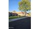 Inviting single-story home featuring lush green lawn, mature trees, and a classic red tile roof at 4116 E Lupine Ave, Phoenix, AZ 85028