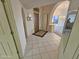View of the foyer with tiled flooring, arched doorways, and a view to the dining room at 4116 E Lupine Ave, Phoenix, AZ 85028