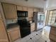 Kitchen with stainless steel refrigerator and black appliances at 4116 E Lupine Ave, Phoenix, AZ 85028