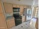 Kitchen with stainless steel refrigerator and black appliances at 4116 E Lupine Ave, Phoenix, AZ 85028