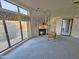 Sunlit living room showcasing a mirrored fireplace, sliding doors, and large windows at 4116 E Lupine Ave, Phoenix, AZ 85028