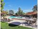 Community pool area with multiple lounge chairs and tables under a sunny blue sky at 4116 E Lupine Ave, Phoenix, AZ 85028