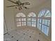 Bright area featuring multiple arched windows with shutter blinds and a ceiling fan at 4116 E Lupine Ave, Phoenix, AZ 85028