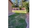 Grassy backyard with desert landscaping featuring gravel beds and block fence at 4130 E Megan St, Gilbert, AZ 85295