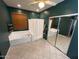 Large bathroom with a whirlpool tub, shower, and a mirrored closet at 4130 E Megan St, Gilbert, AZ 85295
