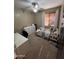 Cozy bedroom with neutral walls and carpet, plus window with wood blinds and a ceiling fan at 4130 E Megan St, Gilbert, AZ 85295