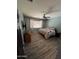 Inviting bedroom with wood floors, a ceiling fan, and a large window with white curtains at 4130 E Megan St, Gilbert, AZ 85295