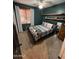 Bedroom featuring a neutral carpet, dark green walls, and an overhead ceiling fan at 4130 E Megan St, Gilbert, AZ 85295