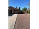 View of the home's front yard with a driveway and low maintenance desert landscaping at 4130 E Megan St, Gilbert, AZ 85295