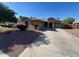 Charming single-story home with a well-maintained lawn and a spacious three car garage at 4130 E Megan St, Gilbert, AZ 85295