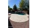 Backyard with a pool featuring a rock waterfall, a hot tub, and desert landscaping at 4130 E Megan St, Gilbert, AZ 85295