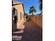 Side yard with desert landscaping and a block privacy fence with a view of a palm tree at 4130 E Megan St, Gilbert, AZ 85295