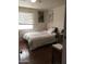 Cozy bedroom featuring natural light from a window, a plush bed, and a study desk at 42 W Thomas Ln, Tempe, AZ 85281