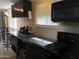 Modern kitchen with stainless steel countertops, dark cabinetry, and updated appliances at 42 W Thomas Ln, Tempe, AZ 85281