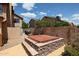 A covered hot tub surrounded by a block wall and desert landscaping in a backyard at 4441 E Sunnyside Ln, Phoenix, AZ 85032