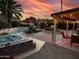 Outdoor oasis with covered patio, hot tub, and swimming pool at sunset at 4441 E Sunnyside Ln, Phoenix, AZ 85032