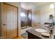 Bathroom featuring granite counters, double sinks, tiled floors, and a shower with glass enclosure and tile surround at 4441 E Sunnyside Ln, Phoenix, AZ 85032