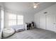 An airy bedroom with a plush chair and desk area features white walls and ample natural light through shuttered windows at 4441 E Sunnyside Ln, Phoenix, AZ 85032