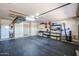 An organized garage with ample storage cabinets, shelving, and black rubber flooring at 4441 E Sunnyside Ln, Phoenix, AZ 85032