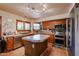 Well-lit kitchen featuring stainless steel appliances, center island, and stylish tile flooring at 4441 E Sunnyside Ln, Phoenix, AZ 85032
