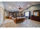 Spacious living room with a ceiling fan, bookshelves and carpet flooring at 4441 E Sunnyside Ln, Phoenix, AZ 85032