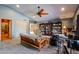 Spacious living room featuring a ceiling fan, carpet flooring and bookshelves at 4441 E Sunnyside Ln, Phoenix, AZ 85032
