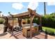 Outdoor kitchen featuring a built-in barbecue, seating, and lighting for entertaining at 4441 E Sunnyside Ln, Phoenix, AZ 85032