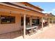 Spacious covered patio featuring pavers, ceiling fan, lighting, and an outdoor dining table at 4441 E Sunnyside Ln, Phoenix, AZ 85032