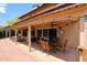 Relaxing covered patio featuring pavers, ceiling fan, lights, and an outdoor dining set at 4441 E Sunnyside Ln, Phoenix, AZ 85032