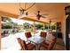 Covered patio featuring an outdoor dining area, seating, and fountain under a decorative pergola at 4441 E Sunnyside Ln, Phoenix, AZ 85032