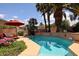Backyard swimming pool with a surrounding stone patio, lounge chairs, and lush landscaping at 4441 E Sunnyside Ln, Phoenix, AZ 85032