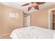 Inviting bedroom with neutral tones, soft carpeting and access to the ensuite bathroom and walk-in closet at 44454 W Oster Dr, Maricopa, AZ 85138