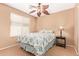 Relaxing bedroom with a ceiling fan, carpeted floors, and a window that provides natural light at 44454 W Oster Dr, Maricopa, AZ 85138