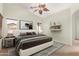 Comfortable bedroom featuring a stylish bed frame, large windows, and neutral decor at 44454 W Oster Dr, Maricopa, AZ 85138