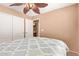 Bright bedroom featuring a comfortable bed, carpeted floor, and a closet for plenty of storage space at 44454 W Oster Dr, Maricopa, AZ 85138